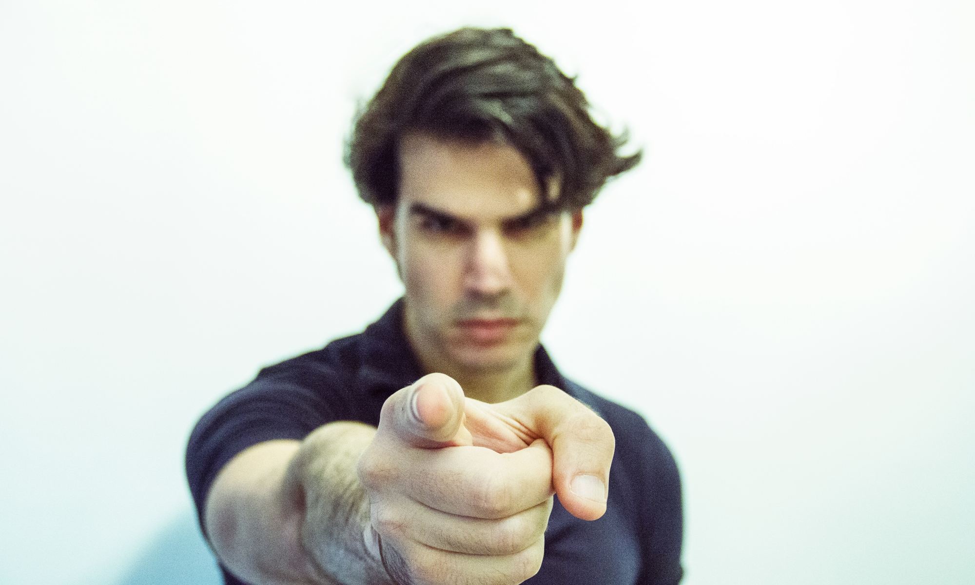 Man blaming someone else by pointing finger at them